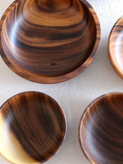 Eco-friendly premium natural wood bowl filled with fresh garden salad.