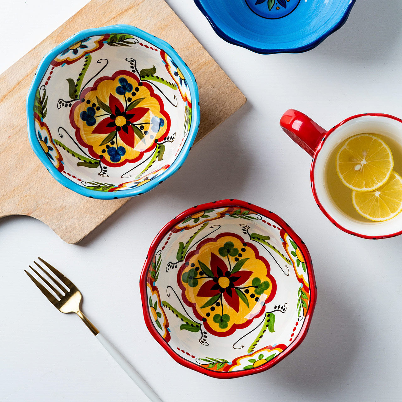 Hand-painted bohemian ceramic bowl with vibrant red floral patterns.