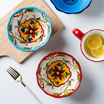 Hand-painted bohemian ceramic bowl with vibrant red floral patterns.