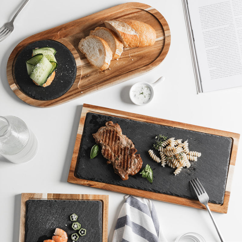 Artisan crafted natural wood charcuterie tray with cheese and fruits.