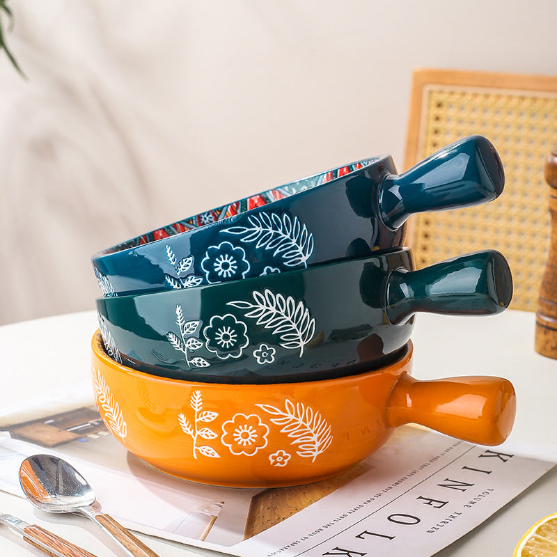 Close-up of the unique flower-shaped handle on the ceramic salad bowl.