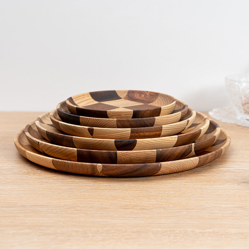 Acacia wood dessert and cheese board on a modern kitchen table.