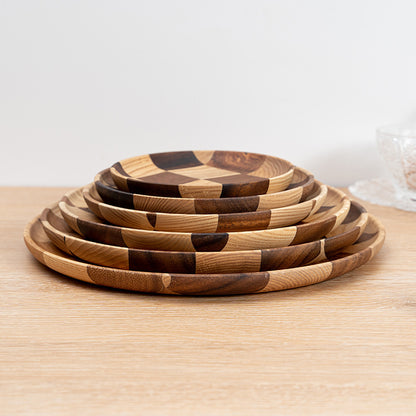 Acacia wood dessert and cheese board on a modern kitchen table.