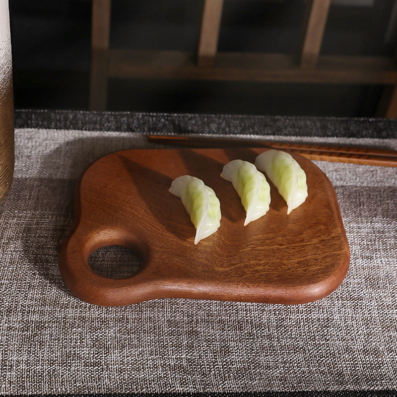Luxury solid ebony wood chopping board for kitchen food prep.