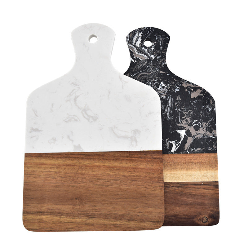 Two-tone white marble and natural wood cutting board with cheese spread.
