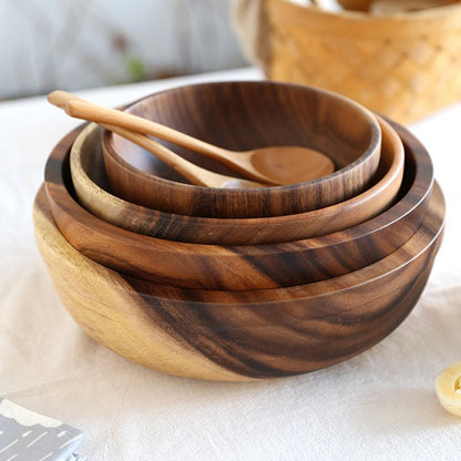 Collection of natural wood salad bowls in various sizes for kitchen dining.