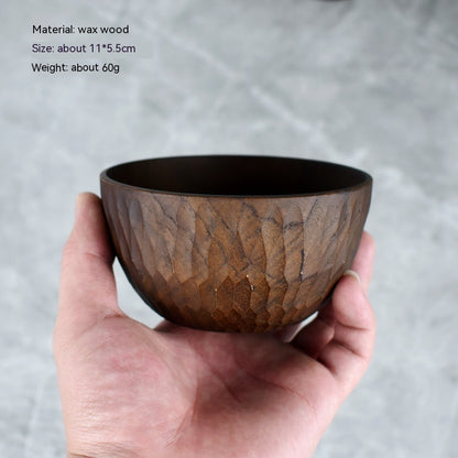Close-up of the natural wood grain and painted details on the bowl.