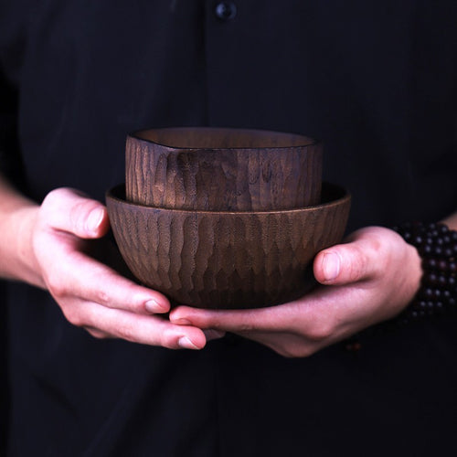 Round handmade wooden cheese bowl filled with diced cheese cubes.
