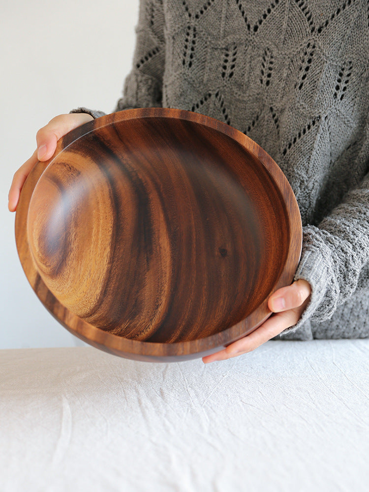 Close-up of the smooth heat-resistant finish on the wooden kitchen bowl.