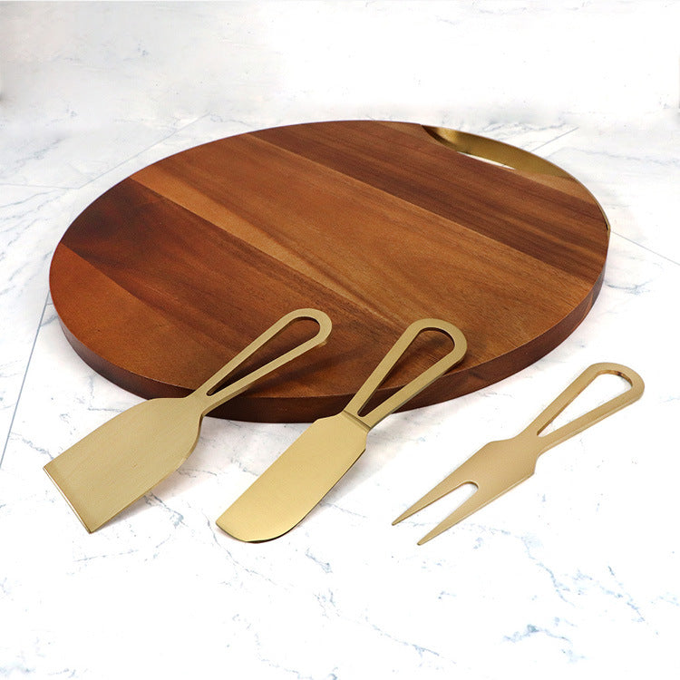 Close-up of specialized cheese knives arranged on an acacia wood board.