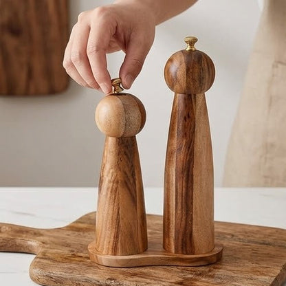 Premium ceramic and acacia wood salt and pepper grinder on a dining table.