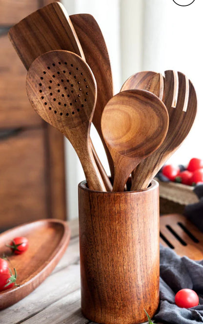 Rustic modern farmhouse style wooden cooking utensils on a kitchen counter.